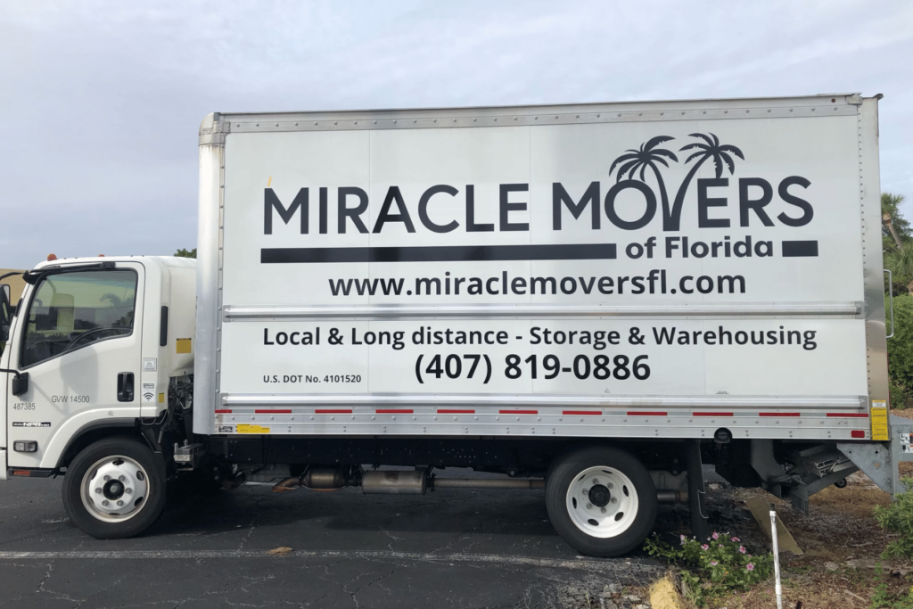 Miracle Movers truck parked in front of a Florida home during a residential move.