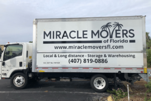 Miracle Movers truck parked in front of a Florida home during a residential move.