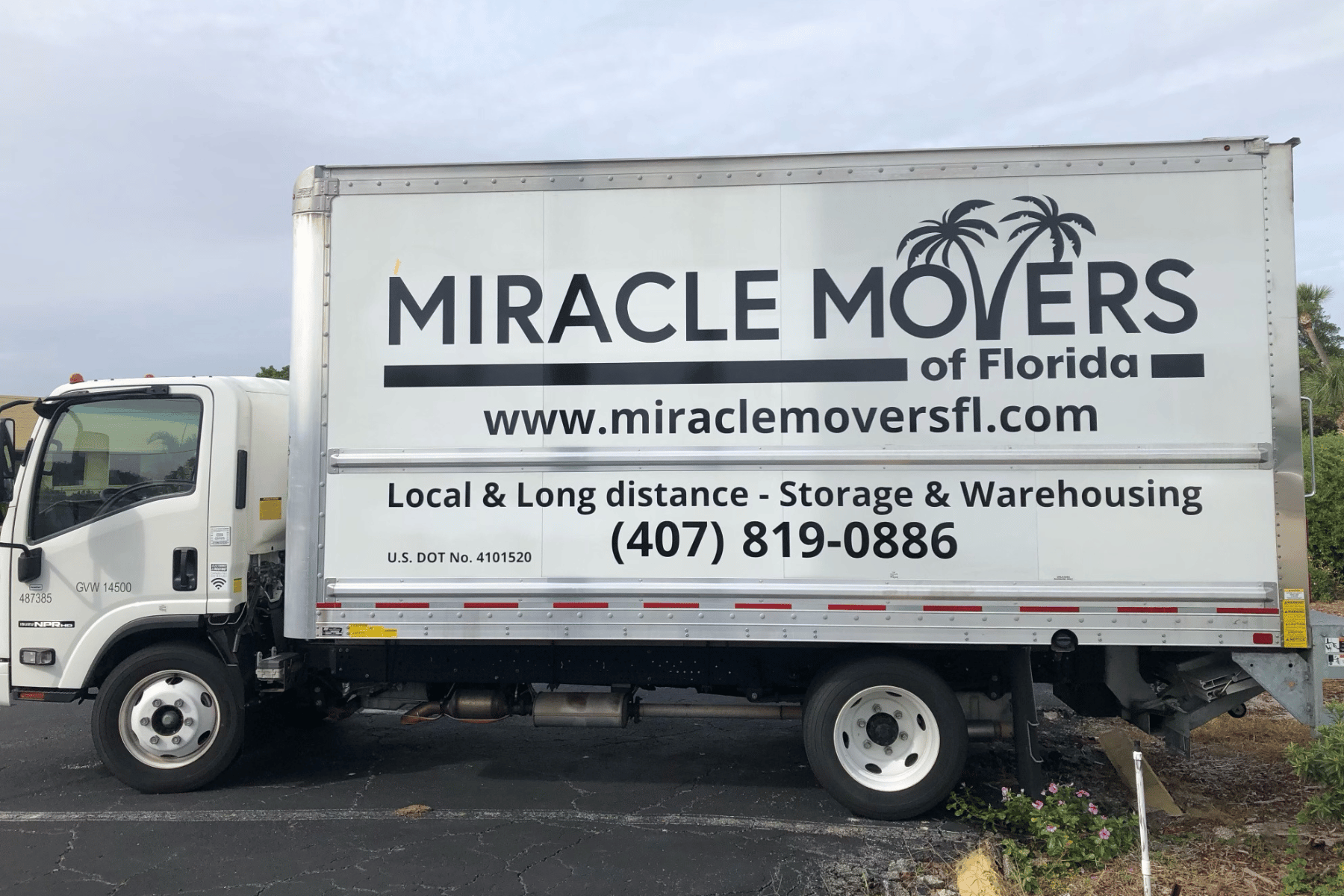 Miracle Movers truck parked in front of a Florida home during a residential move.